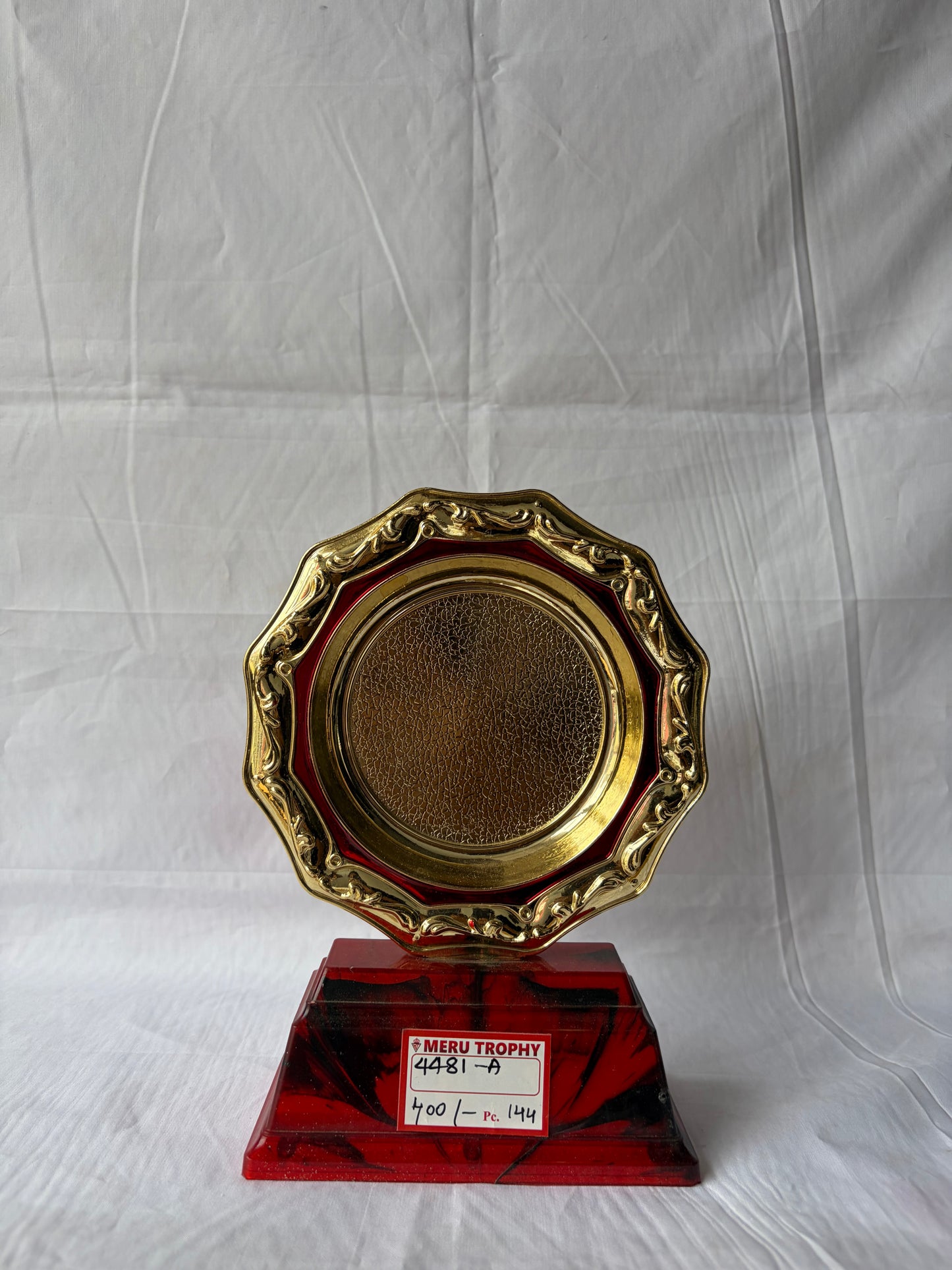 Gold trophy with a red base on a white background