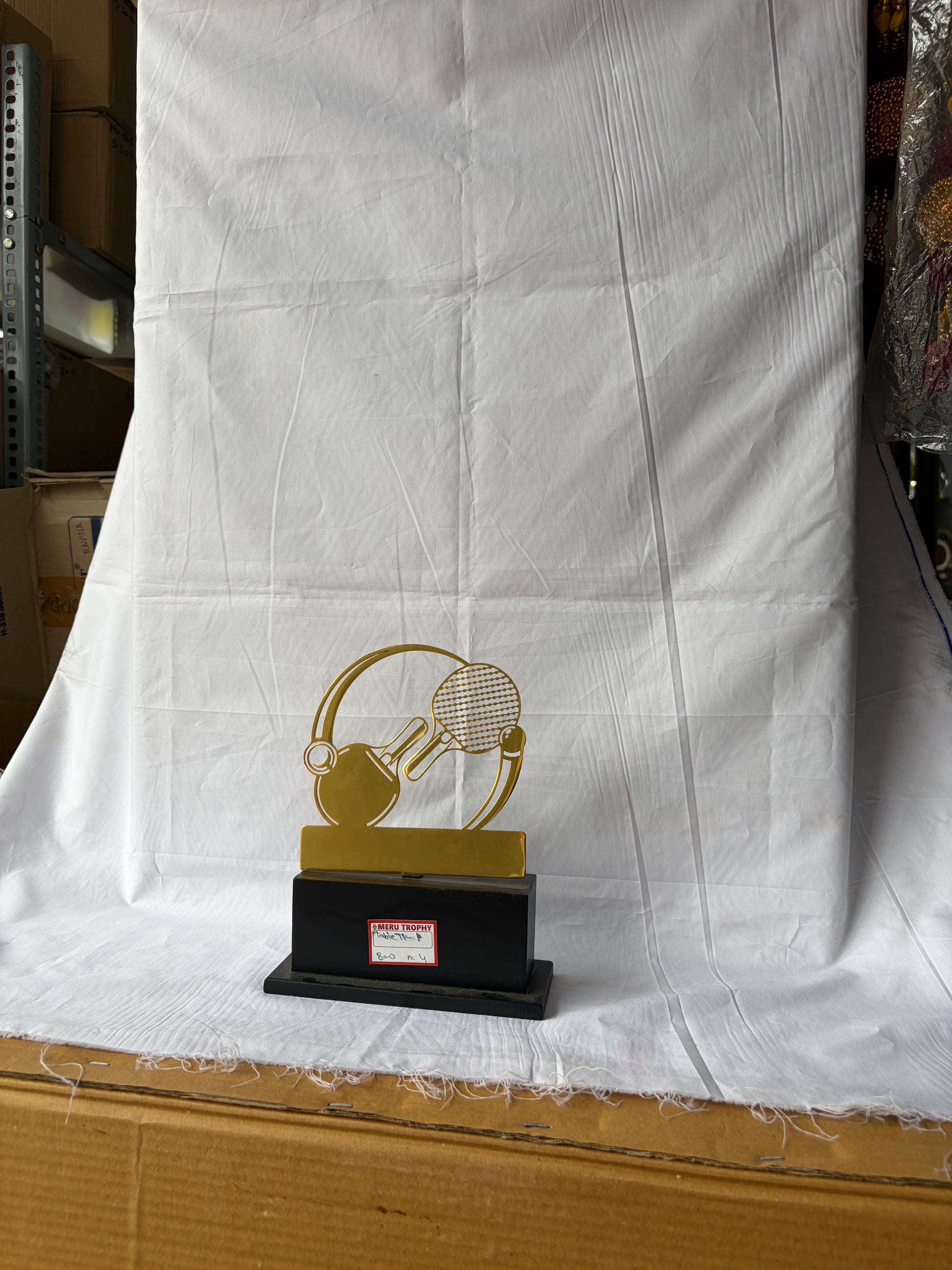 Trophy with a gold design on a white cloth background