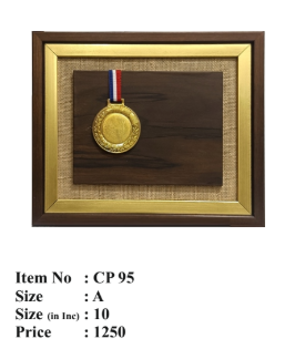 Image of a gold medal mounted on a dark brown wooden plaque; symbolizing achievement and recognition.