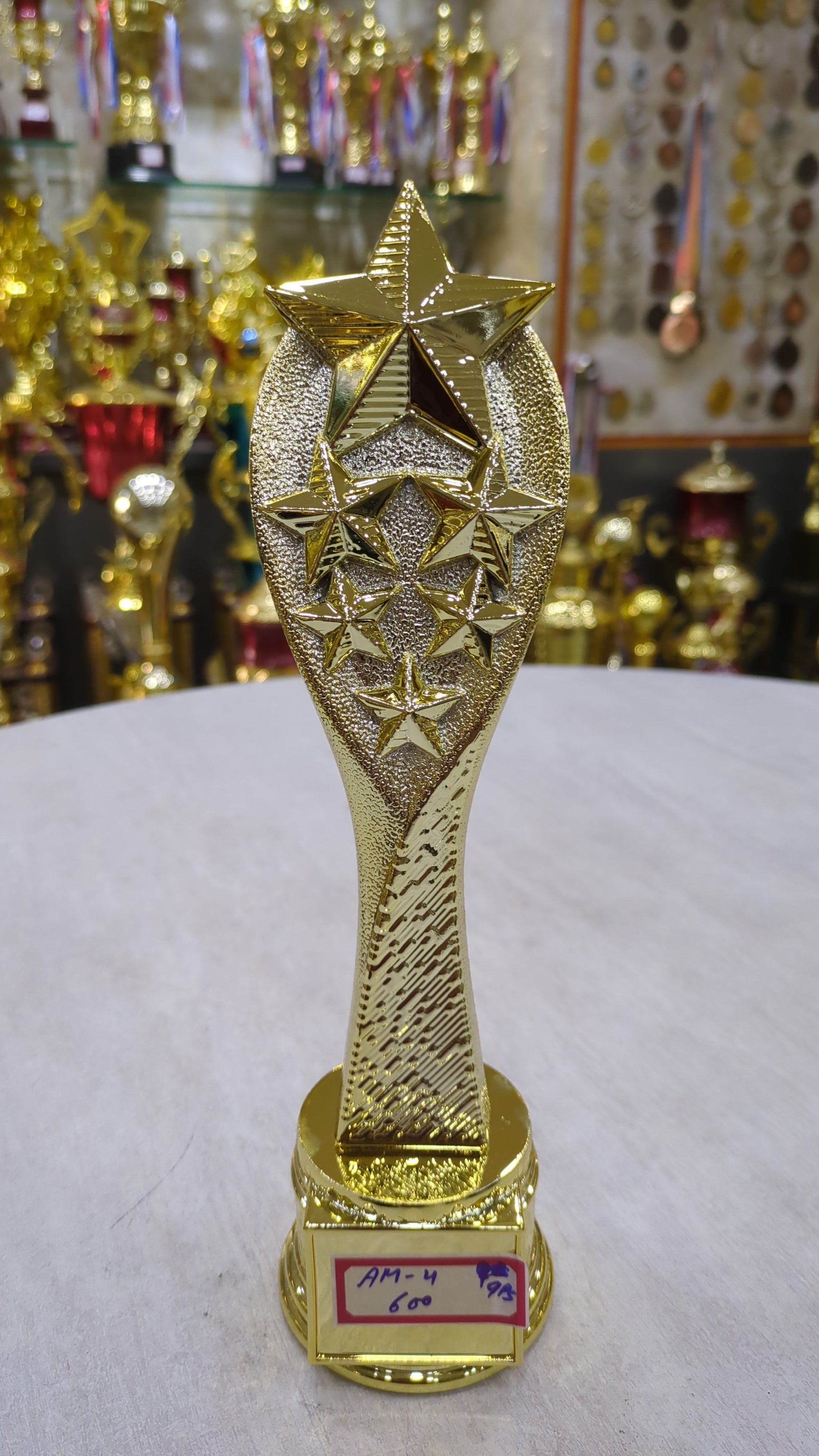Gold star trophy symbolizing excellence and recognition awards.