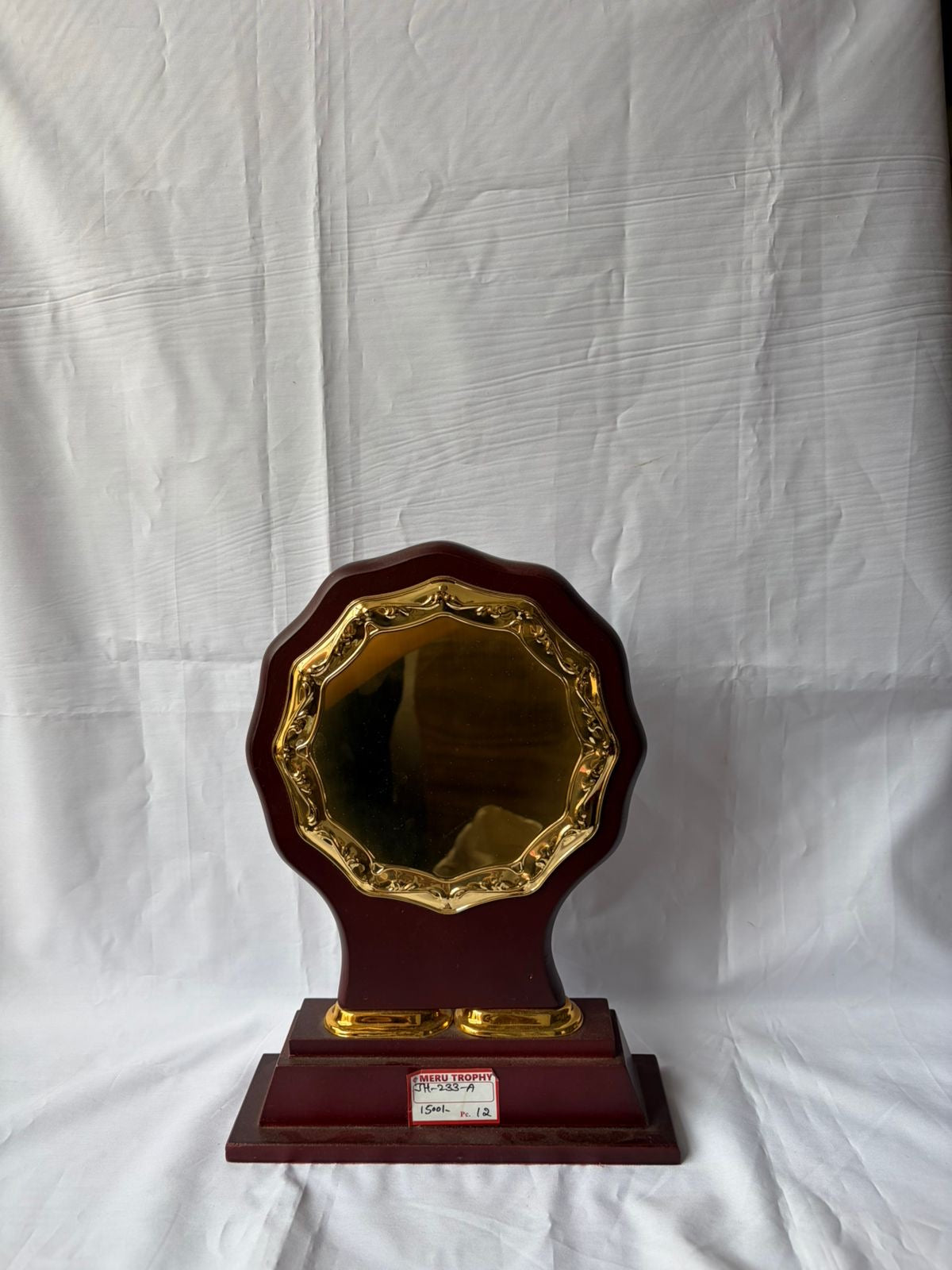 JH 233 A decorative plaques with a scalloped gold metal plate on a dark mahogany wood base for corporate recognition.